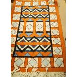 A decorative hand made Zulu rug with applied label to the reverse,