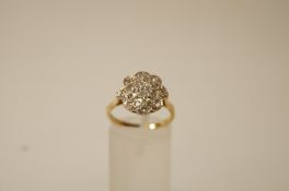 A seventeen stone diamond cluster 18 ct gold cluster ring,