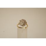 A seventeen stone diamond cluster 18 ct gold cluster ring,