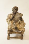 An Austrian bronze Arab figure of a man seated on a chair writing, impressed marks, no.