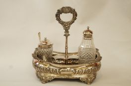 A George IV silver cruet stand with three bottles, makers mark W.B.