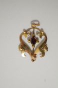 An Edwardian garnet pendant, stamped '9ct', of scroll design, 3.1 cm long excluding the bale, 1.