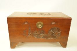 A carved camphor wood chest with stepped bracket feet, 58cm high, 102cm wide,