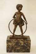 A 20th century bronze of a girl with a hoop on a marble base,