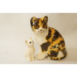 A Winstanley cat, size three, 20cm high and a Royal Doulton cat, 9.