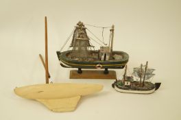 A painted model of a fishing boat on a stand, 23cm high, another smaller and a small pond yacht,