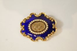 A Victorian mourning brooch, of oval shaped outline with C scroll borders,