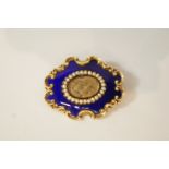 A Victorian mourning brooch, of oval shaped outline with C scroll borders,