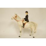 A Beswick Huntswoman, seated on a dapple grey horse, no.