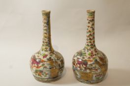 A pair of Chinese porcelain vases painted in underglaze blue and outside decorated in canton enamel