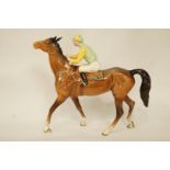 A Beswick horse and jockey, wearing yellow and green silk, printed marks in black,