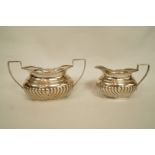A matched silver cream jug and sugar bowl, by William Aitken, Birmingham 1903 and 1904,