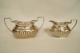 A matched silver cream jug and sugar bowl, by William Aitken, Birmingham 1903 and 1904,