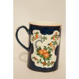 An 18th century Worcester porcelain mug painted with Chinese style flowers on a scale blue ground,