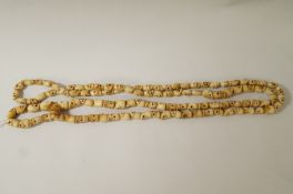 A 20th century Tibetan bone necklace,carved as skulls,