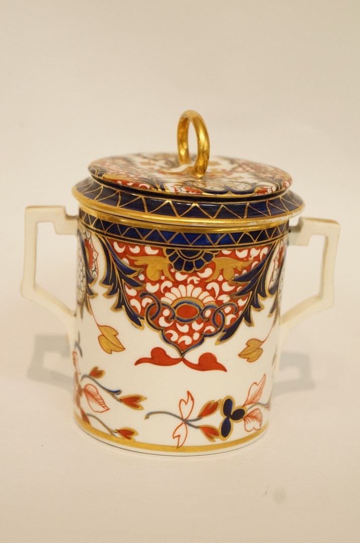 An early 19th century Derby chocolate cup and cover, with imari decoration,