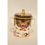 An early 19th century Derby chocolate cup and cover, with imari decoration,
