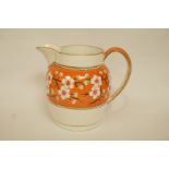 A Wedgwood pearlware jug painted with prunus on an orange ground within gilt line borders,