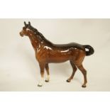 A Beswick figure of a bay horse, printed marks in black, 21.