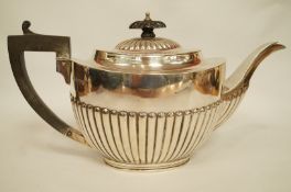 A silver teapot, by Barker Brothers, Chester 1919, of oval gadrooned form, 28 cm long, 702 g (22.