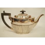 A silver teapot, by Barker Brothers, Chester 1919, of oval gadrooned form, 28 cm long, 702 g (22.