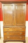 A George IV mahogany linen press, with two panelled doors enclosing five slides,