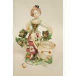 A Bow porcelain figure of a girl standing before a basket with bocage behind,