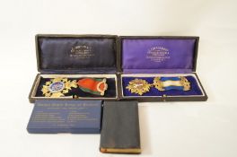 A silver gilt and enamelled Masonic medal; and another; both in cases; a book of Craft Ceremonies,