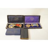 A silver gilt and enamelled Masonic medal; and another; both in cases; a book of Craft Ceremonies,