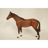 A Beswick figure of a bay horse with matt glaze, printed marks in black,