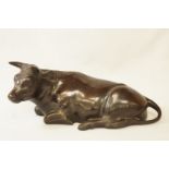 A 20th century bronze model of a cow, unsigned, 29cm long,