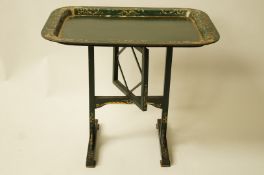 A Victorian painted papier mache tray adapted as a tea table,
