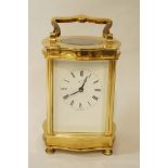 A modern brass carriage clock with a white enamel dial, by Henley,