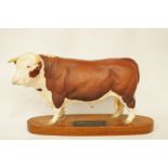 A Beswick figure of a Hereford bull on a wooden plinth with title plaque,