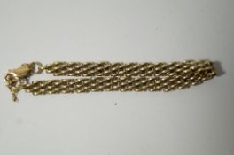 A 9ct gold bracelet, of three bar design, to a lobster claw clasp, 11.