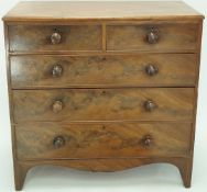 An early 19th century mahogany chest of two short and three long drawers with turned handles and