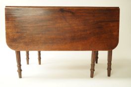 A Victorian mahogany drop leaf dining table, on turned legs, 71cm high, 132cm long,