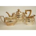 A matched three piece silver tea service, London 1930 and 1934,