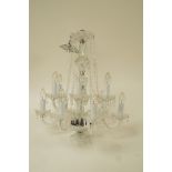 A modern twelve branch glass chandelier, with swags and drop pendants,