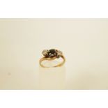 A three stone diamond and sapphire 9ct gold ring, the two single cuts illusion set, finger size J,