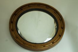 A circular Regency style convex mirror with gilt frame,