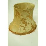 A yellow silk lamp shade with beaded border,
