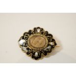 A Victorian mourning brooch, of oval shaped outline,