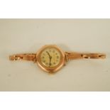 De Luxe, a lady's wrist watch, the gilt dial with black Arabic numerals and hands,