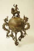 An early 20th century oriental brass koro, on a three dragon leg base, with three matching handles,