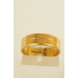 An 18ct gold patterned wedding ring,