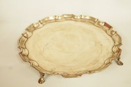 A silver salver, makers mark obscured, Birmingham 1921, of circular shaped outline with moulded rim,