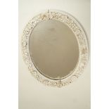 A late 19th century oval mirror,