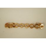 A 1950s bracelet, stamped '9ct', of open circular links joined by baton links, 19cm long,