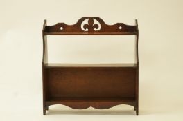 A late Victorian mahogany three tier standing book shelf with pierced crest, 60cm high, 58cm wide,